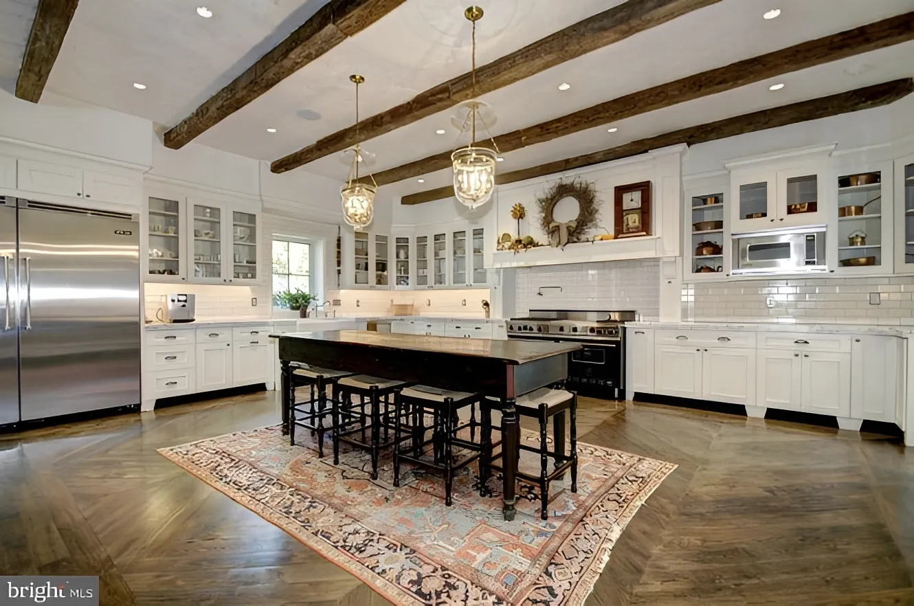 Spacious kitchen with wooden beams and island.