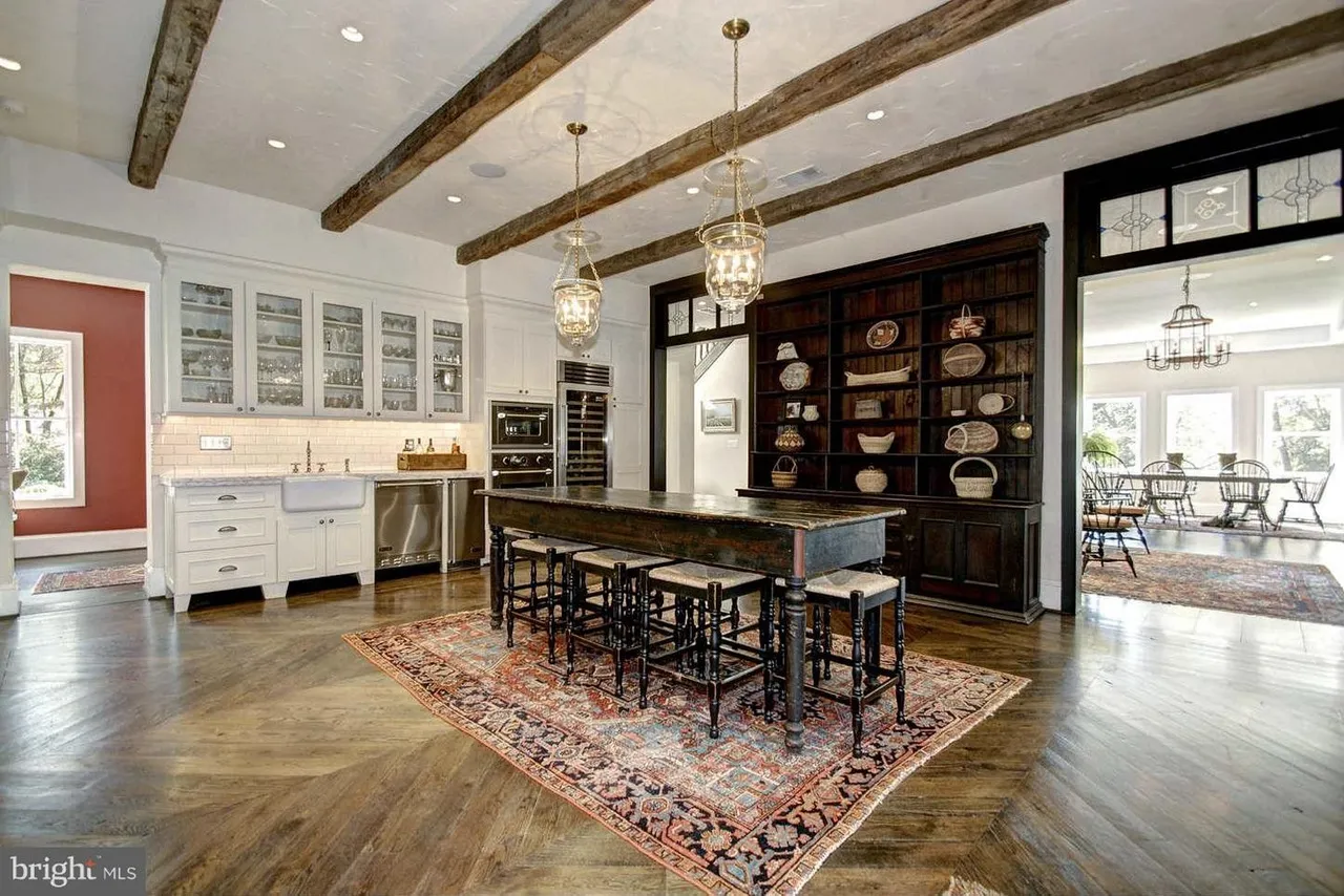 Rustic kitchen with wooden beams and island.