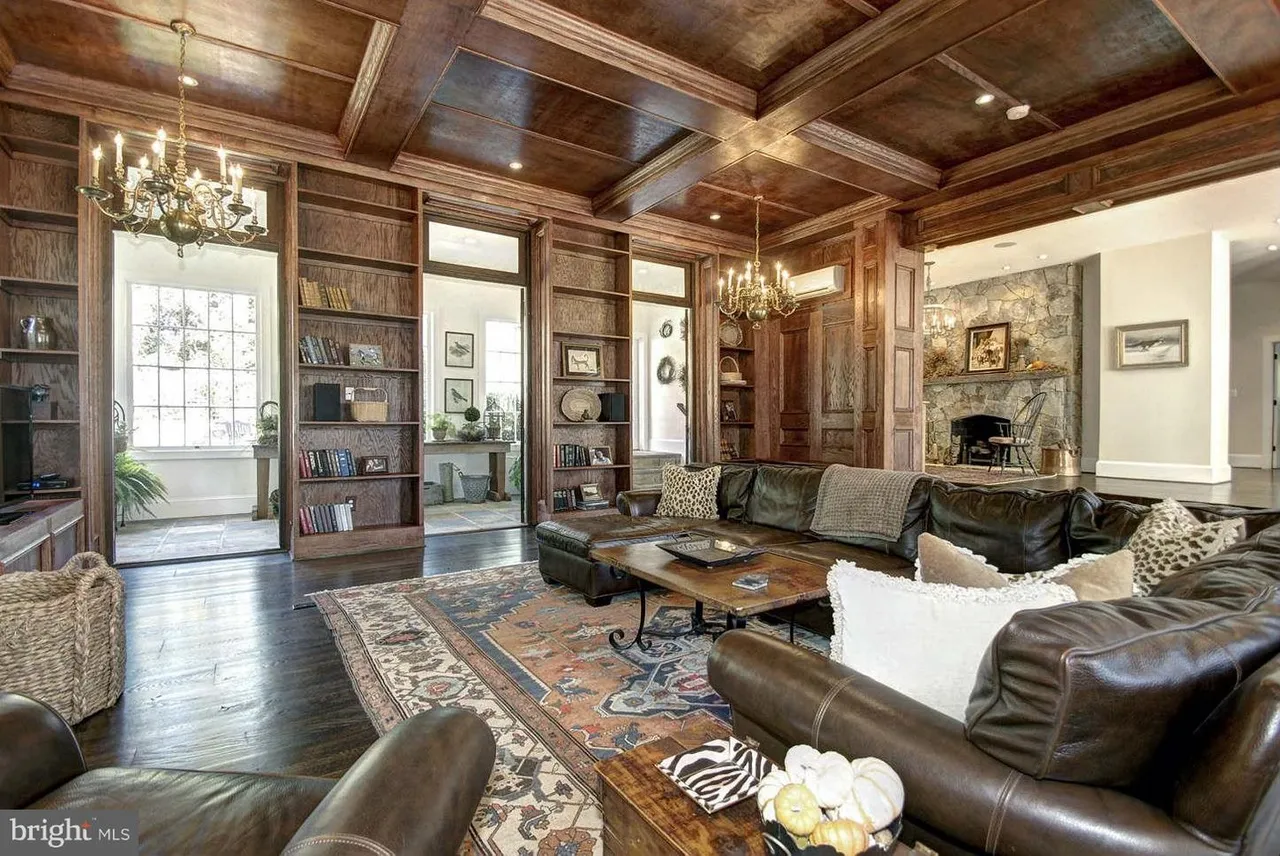 Luxurious library with leather sofas and chandeliers.