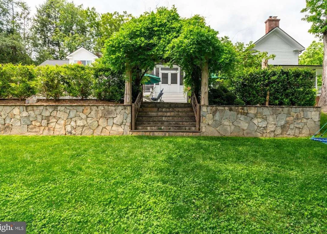 Stone steps leading to garden archway.