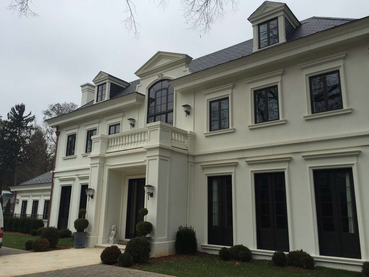 Elegant two-story white mansion with windows.