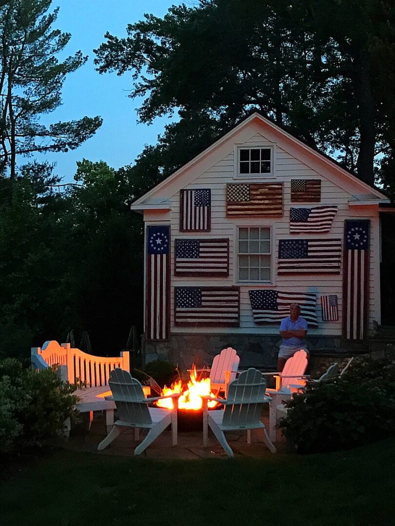 Fire pit with chairs and American flags.