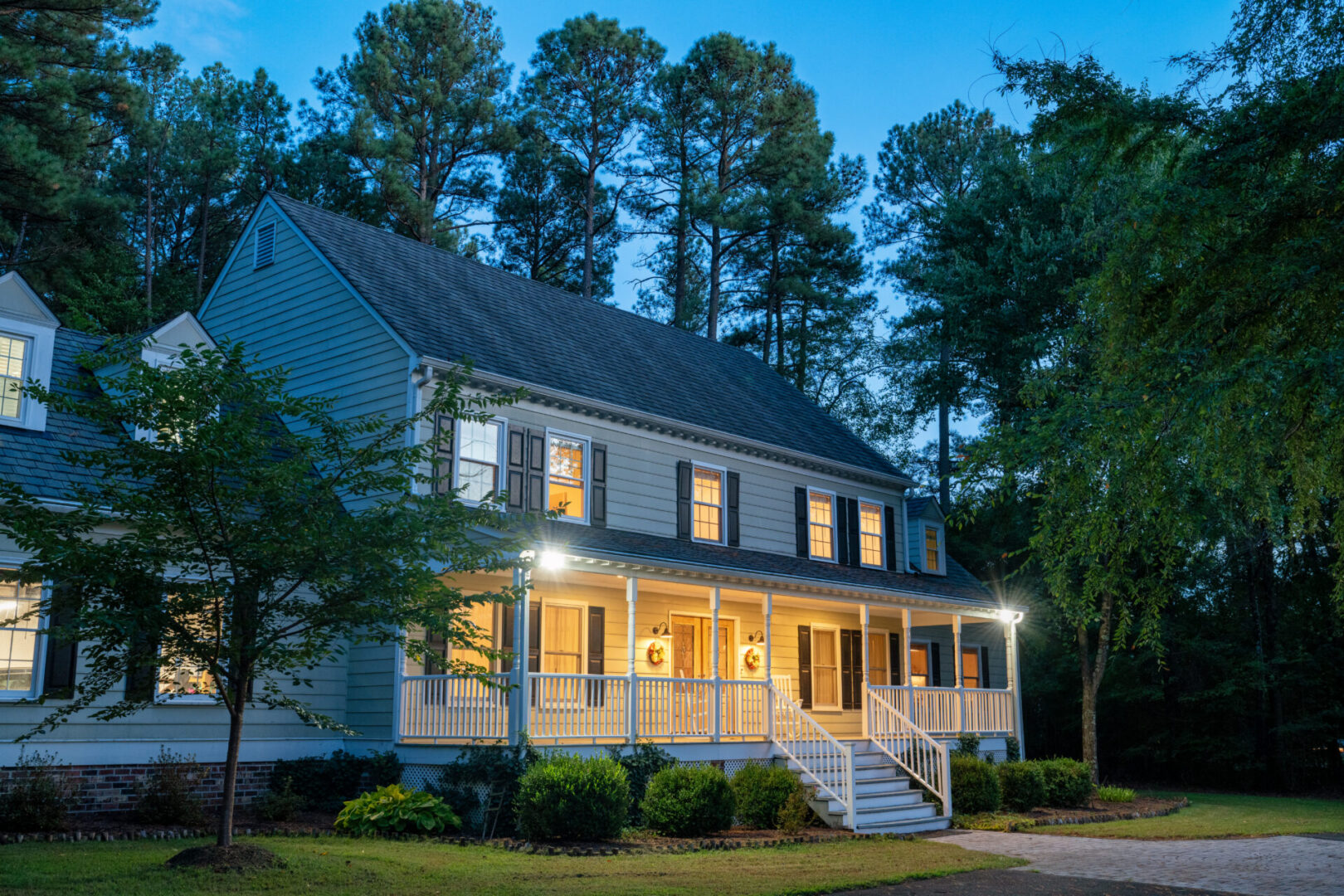 Illuminated Colonial style house at dusk