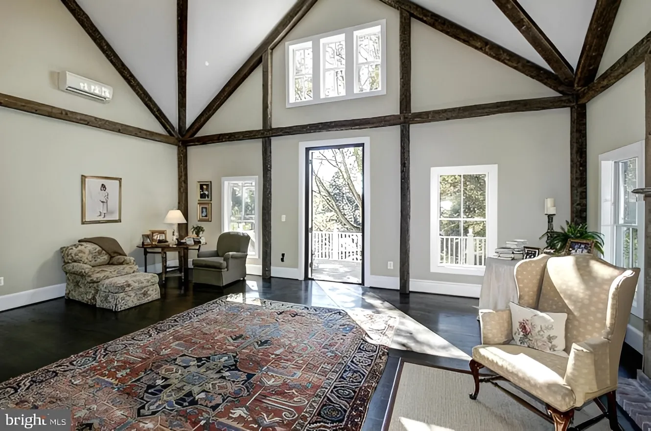 Spacious living room with exposed wooden beams.